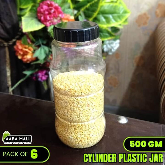 Clear plastic jar with black lid containing yellow grains on a dark surface with floral and curtain background.