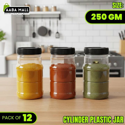Three cylindrical plastic jars with black lids on a kitchen counter, containing different colored powders.