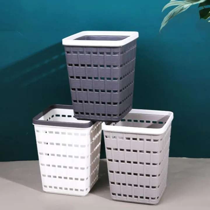 Three laundry baskets stacked against a teal wall. AABA MALL 