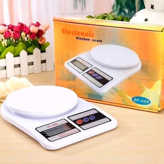 Digital kitchen scale with packaging on a wooden surface