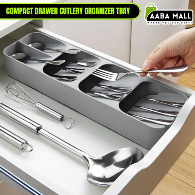 Multi-layer kitchen drawer cutlery organizer tray in grey, shown with spoons, forks, and knives stored vertically in the tiered, overlapping compartments for maximum space saving.