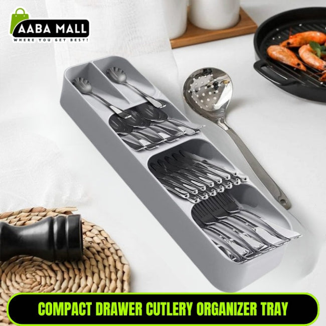 Multi-layer kitchen drawer cutlery organizer tray in grey, shown with spoons, forks, and knives stored vertically in the tiered, overlapping compartments for maximum space saving.