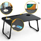 Black folding laptop desk with cup holder and power outlet on a white background