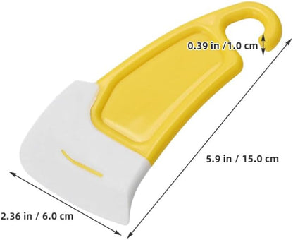 Flexible rubber scraper removing food residue from cookware