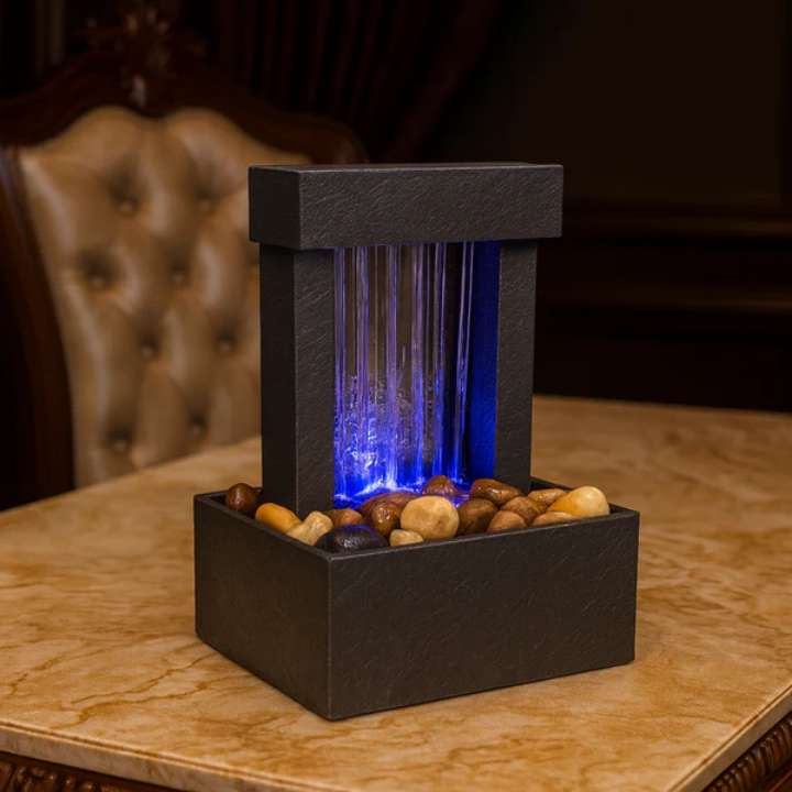 Tabletop water fountain with LED lighting on a marble surface