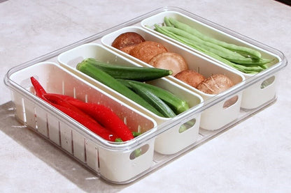 Divided food container with compartments of vegetables and mushrooms on a light background