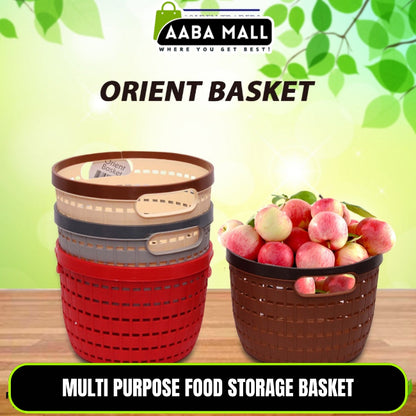 Black multipurpose wire storage basket filled with fresh red apples and oranges, sitting on a kitchen countertop, demonstrating air flow and fruit storage.