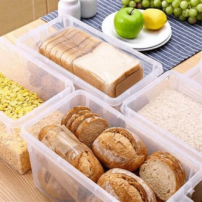 Clear plastic containers with bread slices on a wooden table with fruits in the background