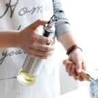 Stainless steel covered glass oil bottle for countertop use