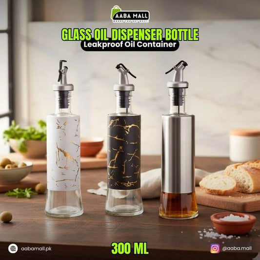 Three glass oil dispenser bottles on a kitchen counter with 'AABA MALL' branding.