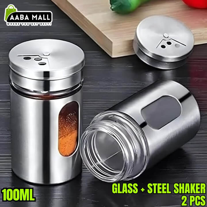 Two stainless steel shakers with glass bodies on a wooden surface, labeled 'AABA MALL'.