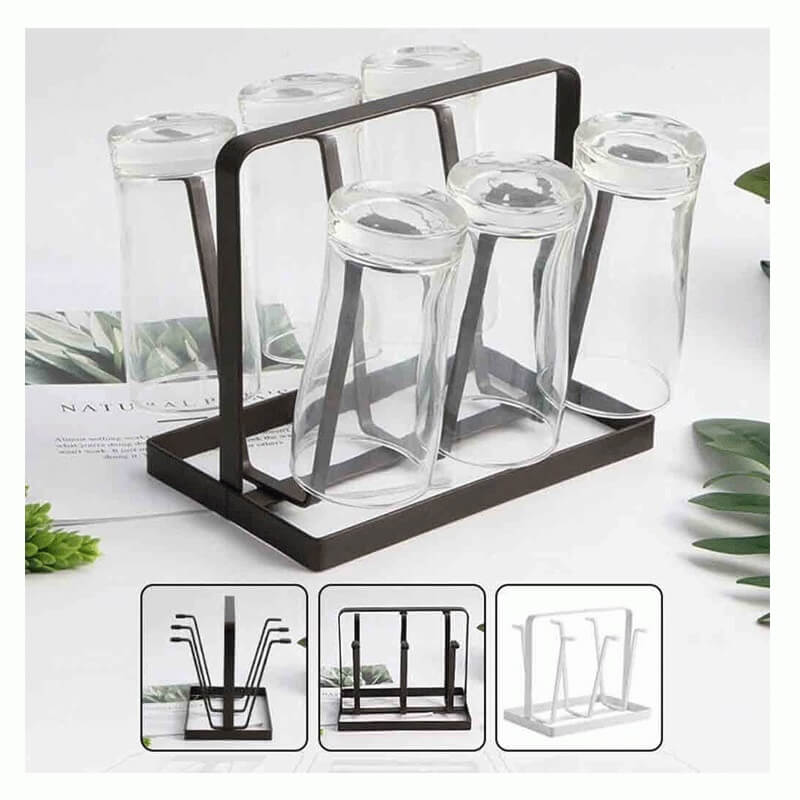 Glass drink holders with a black metal stand on a white surface with greenery.