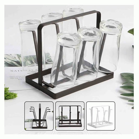 Glass drink holders with a black metal stand on a white surface with greenery.