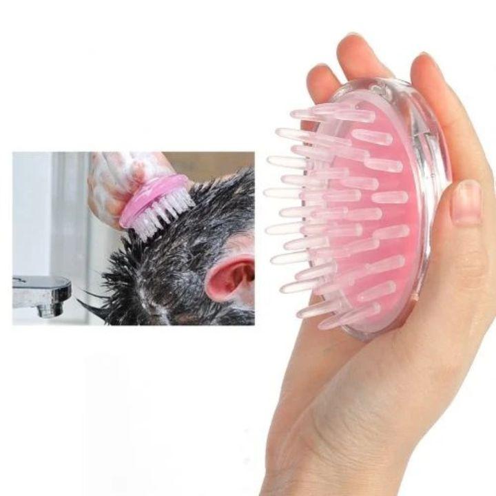 Pink pet grooming brush held by a hand with inset showing use on a dog's fur.