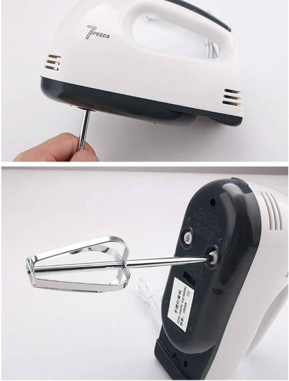 Electric hand mixer with beaters on a white background