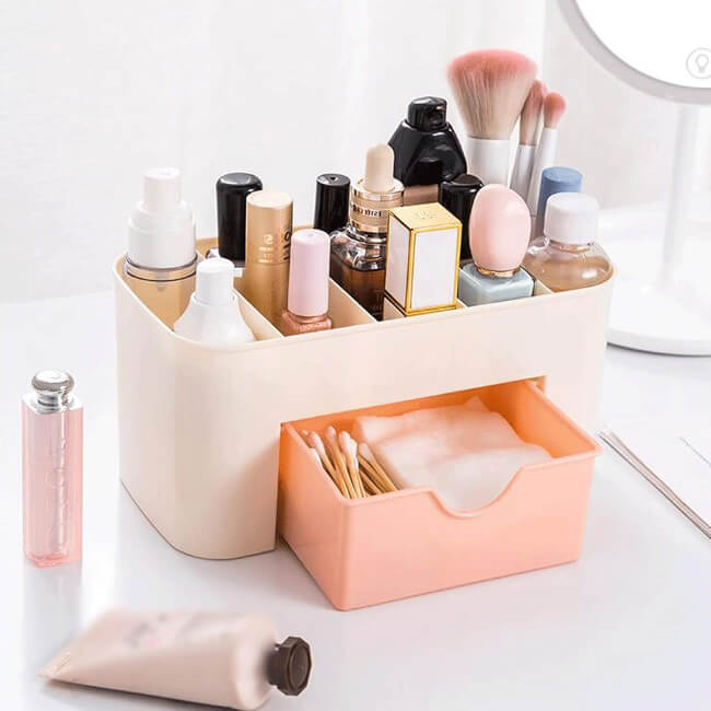 Makeup organizer with various cosmetic items on a white surface