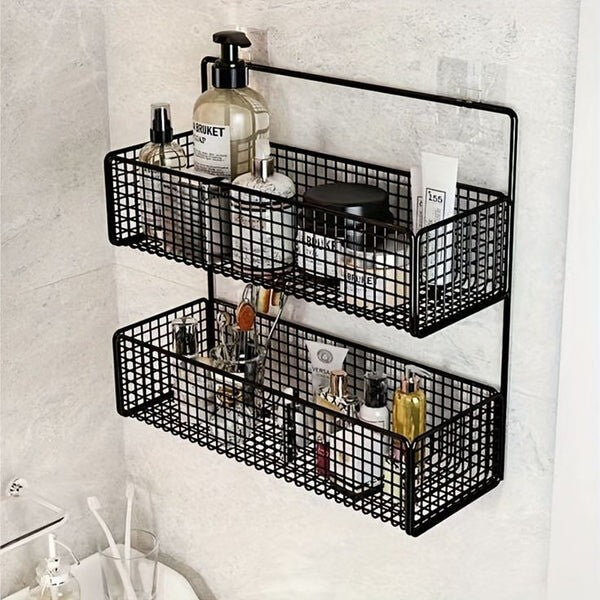 Black metal wall-mounted storage baskets with bathroom products on a tiled wall.