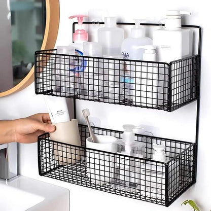 Black wire wall-mounted storage baskets with toiletries on a white wall.