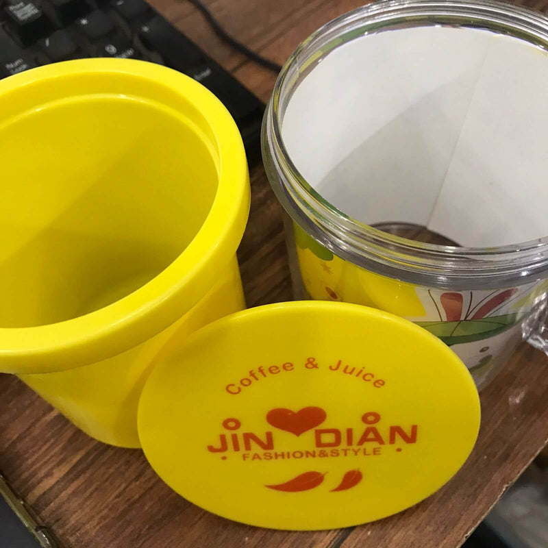 Yellow container with a lid featuring 'Jin Dian' branding on a wooden surface.