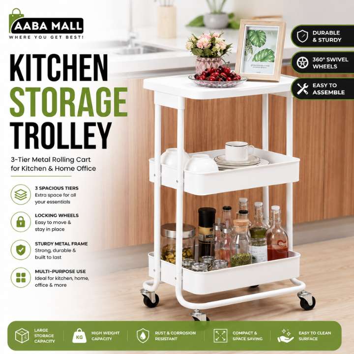 A white 3-tier metal rolling cart labeled as a kitchen storage trolley, shown in a kitchen setting with bottles, jars, and decorative items on its shelves. The image includes marketing text and feature icons on a green and white layout.