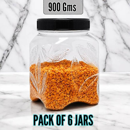 Clear PLASTIC jar with orange contents and black lid on a marble background, labeled '900 Gms' and 'Pack of 6 Jars'.