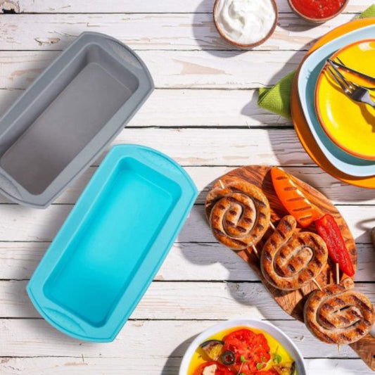 Flexible non-stick silicone loaf pan in red, shown holding a baked banana bread loaf that is easily being removed from the mold, illustrating the easy release.