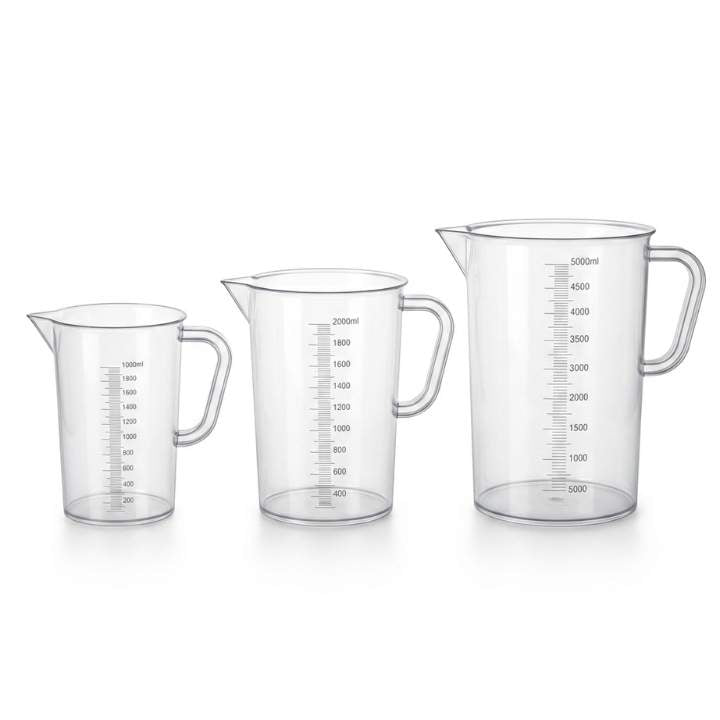 Set of three clear measuring jugs with measurement markings on a white background