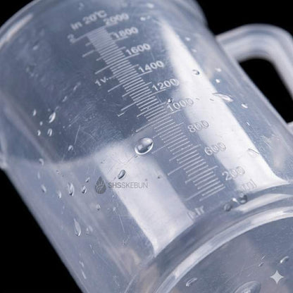 Clear plastic container with measurement markings on a black background