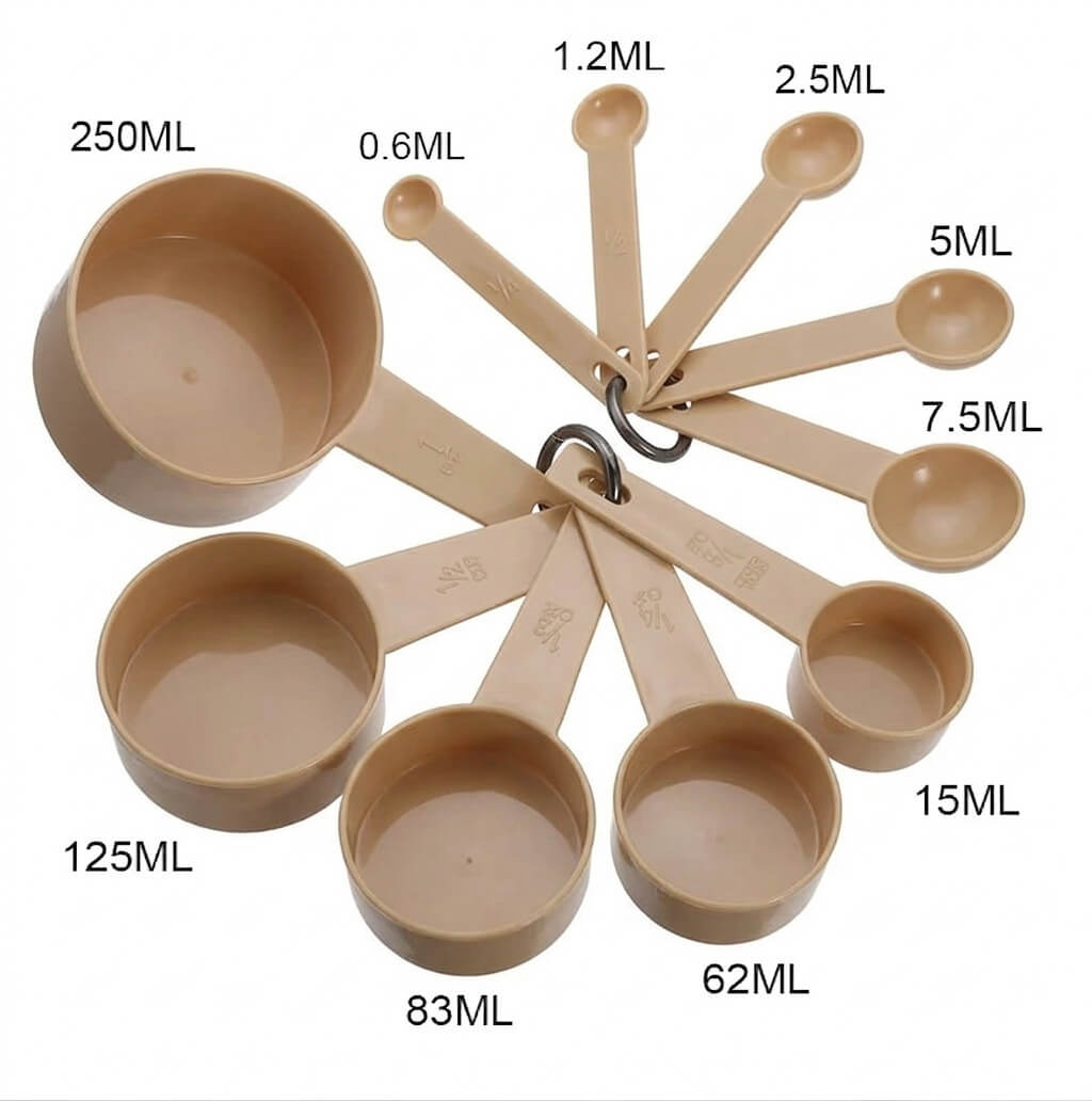 Set of beige measuring cups with volume markings on a white background
