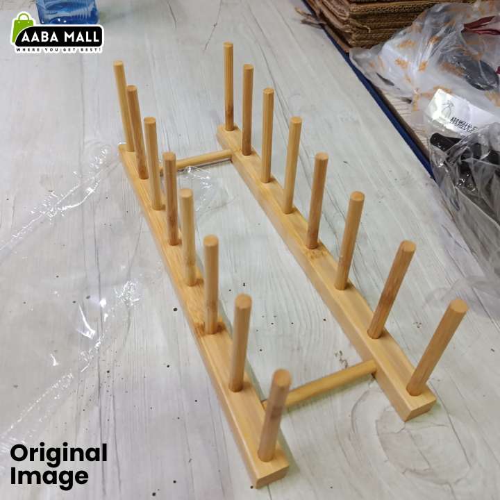 A light natural wood drink coaster or cup holder with multiple upright pegs, shown on a light gray floor with plastic wrapping visible in the background. AAAB Mall logo appears in the top-left corner, and 'Original Image' text appears in the bottom-left.