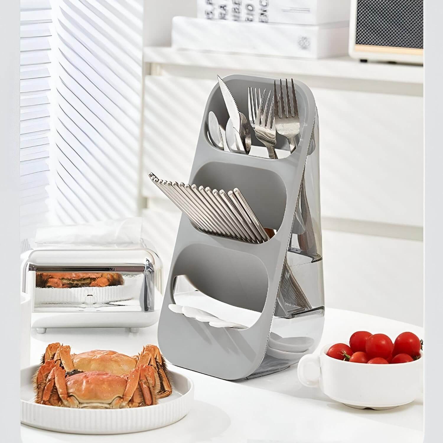 Gray knife block with cutlery on a kitchen counter with a white background