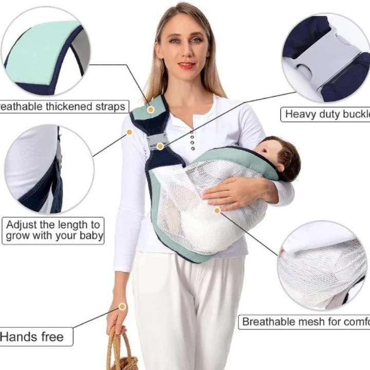 Woman holding a baby in a carrier with features highlighted