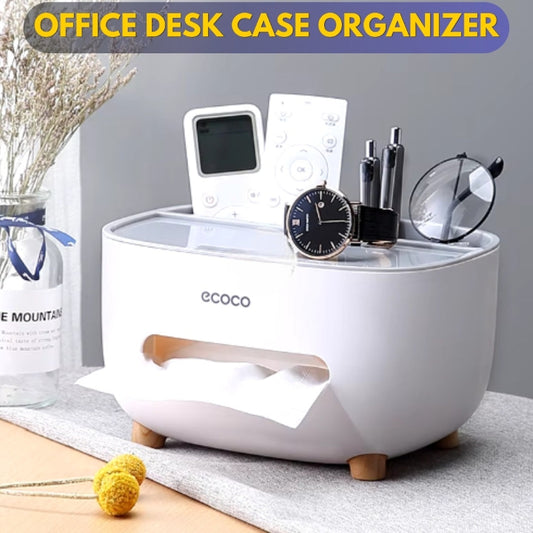A white Ecoco multifunctional tissue storage box on an office desk, organizing various items such as a phone, remote control, and glasses. The box has a removable double-layer design and a non-slip base.