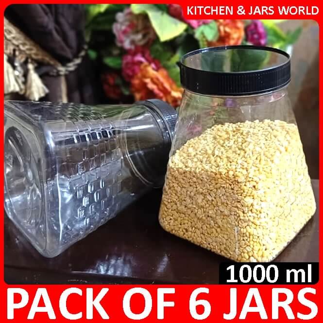 Pack of 6 transparent jars with black lids, one filled with yellow grains, on a table.