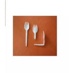 White plastic forks on a brown background