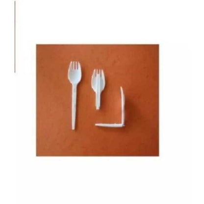 White plastic forks on a brown background