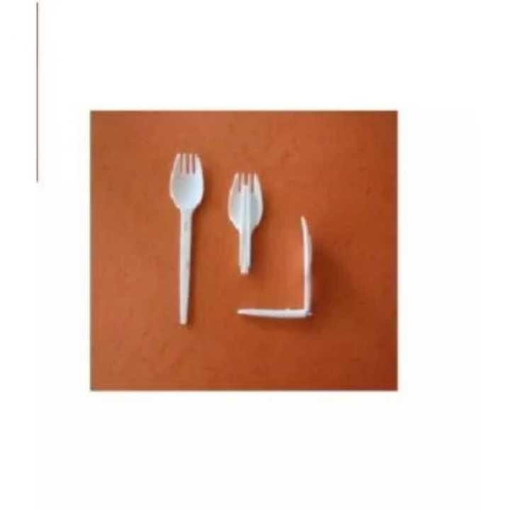 White plastic forks on a brown background