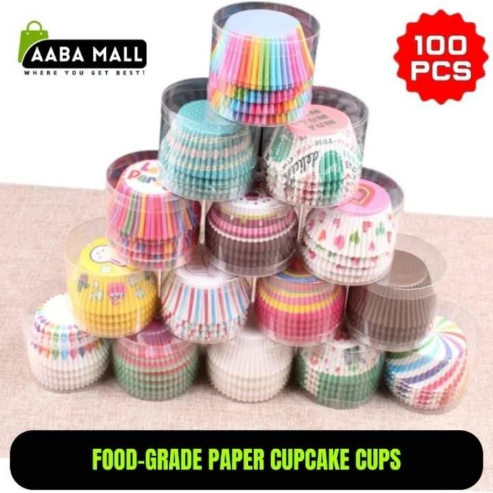 Stack of colorful paper cupcake cups with 'AABA MALL' branding and text indicating 100 pieces.