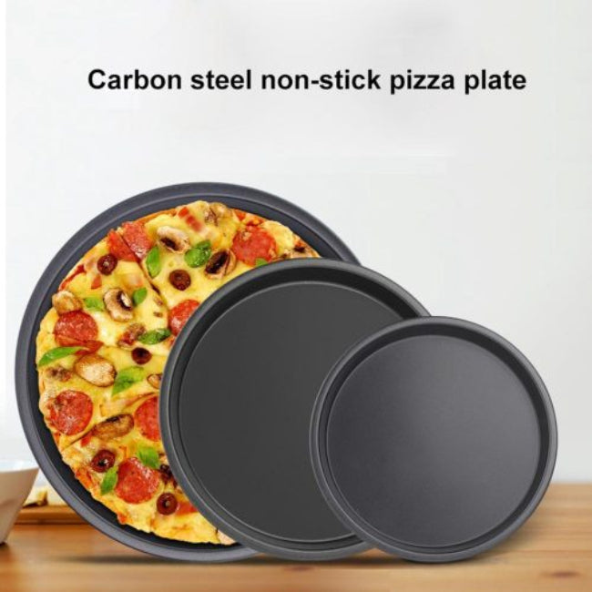 Set of three round black non-stick pizza pan trays, stacked together to show the 9-inch, 10-inch, and 11-inch multi-sizes, sitting on a kitchen counter.