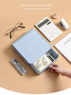 Blue stationery organizer with various items on a beige surface