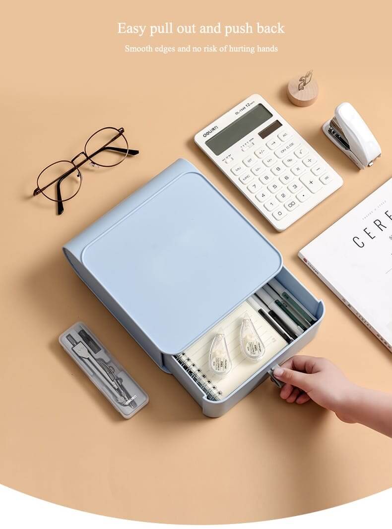 Blue stationery organizer with various items on a beige surface
