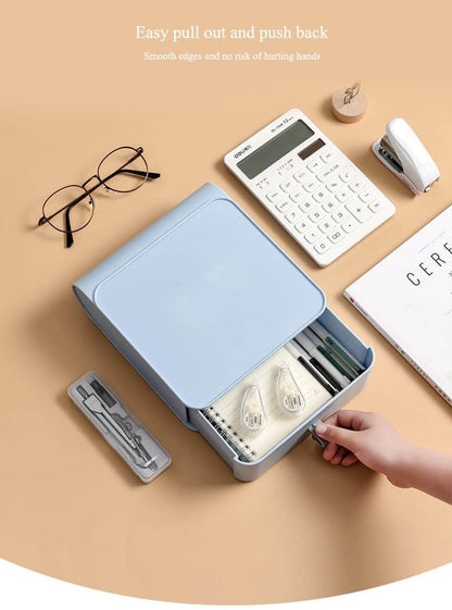 Blue stationery organizer with various items on a beige surface