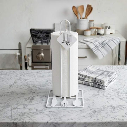 White paper towel holder with paper towels on a marble countertop in a kitchen.