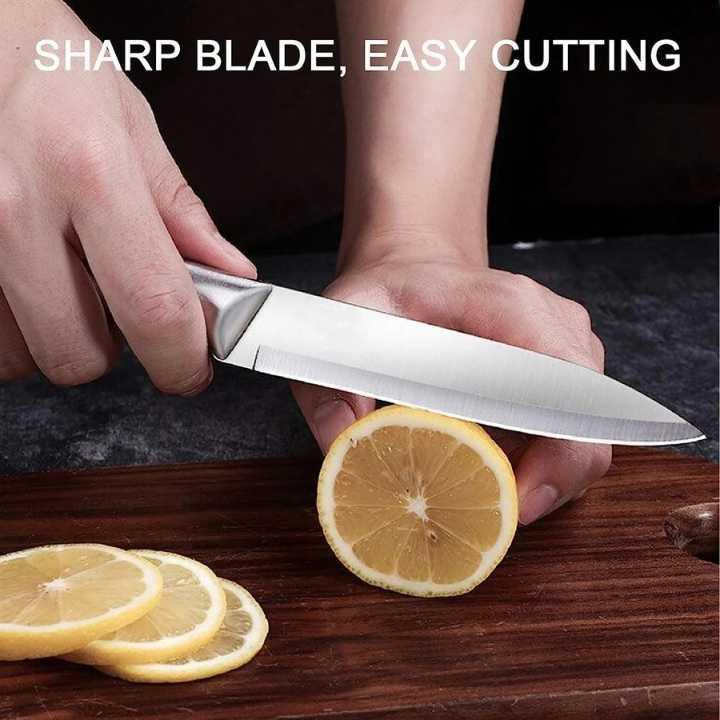 Person using a sharp knife to cut lemons on a wooden surface with text 'Sharp Blade, Easy Cutting'.