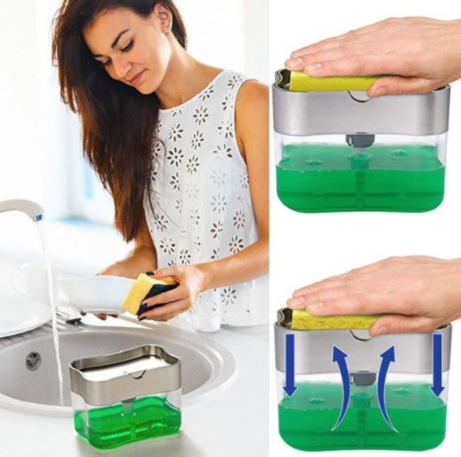 A white plastic push soap dispenser with a clear reservoir, showing a yellow scrub sponge resting on top of the pump mechanism, positioned next to a kitchen sink.