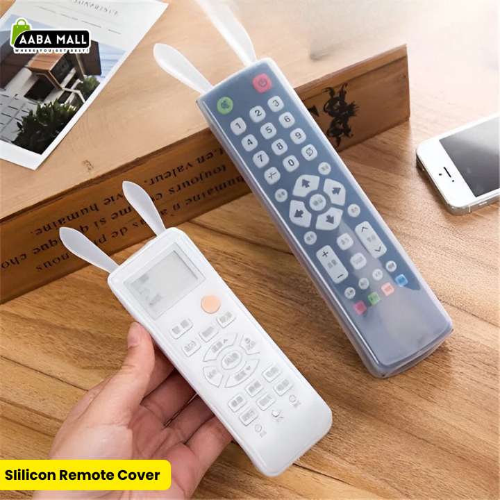 Two semi-transparent silicone remote control covers with cute rabbit ears, one on a white AC remote and one on a black TV remote,  'AABA MALL' branding.