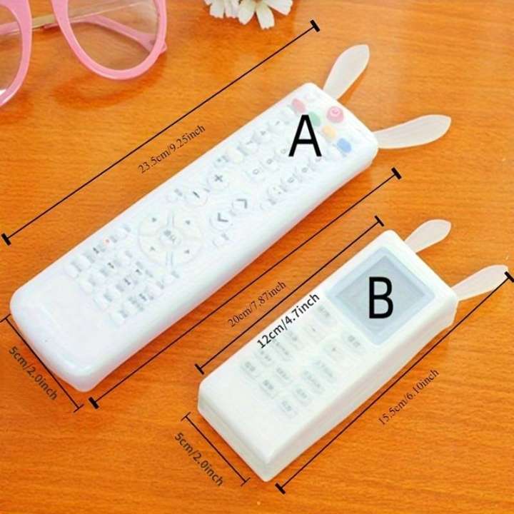 Two white rectangular containers with measurement lines on a wooden surface