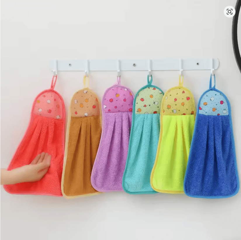 Colorful hanging towels with polka dot patterns on a white wall.