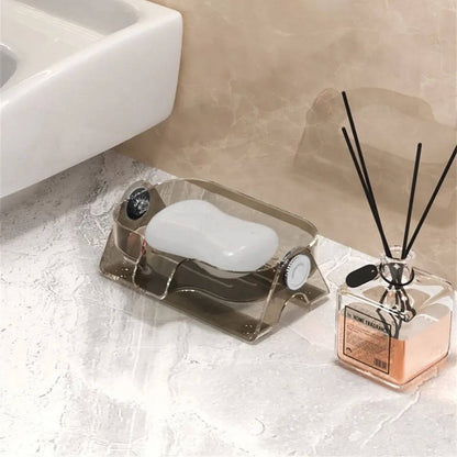 Soap dish with bar of soap and diffuser on a bathroom counter