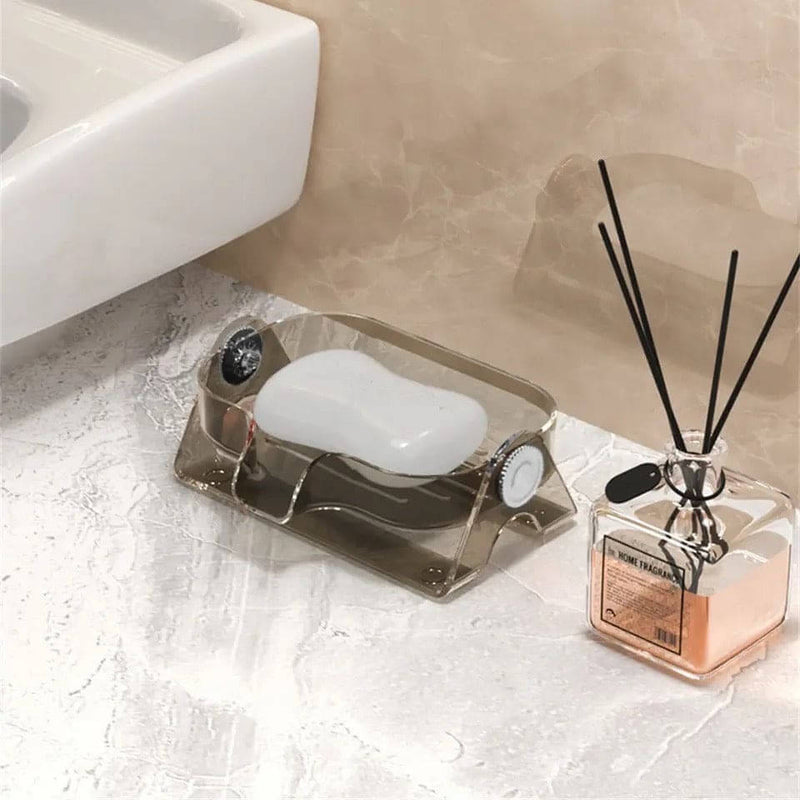 Soap dish with bar of soap and diffuser on a bathroom counter